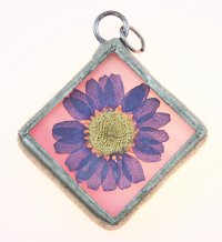 Pressed dried wildflower pendant in diamond-shaped silver frame